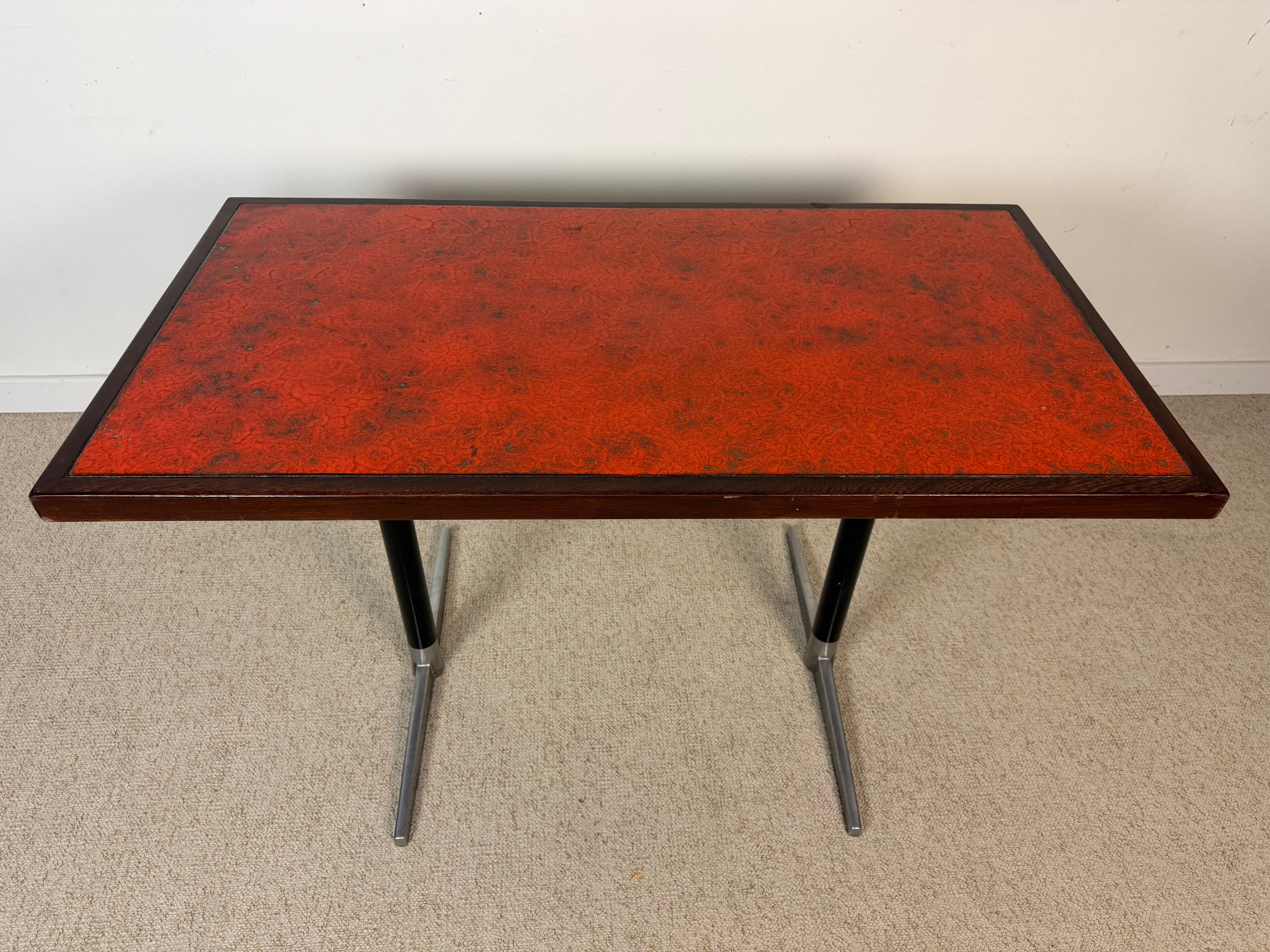 Vintage bistro table with orange-red ceramic.