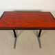 Vintage bistro table with orange-red ceramic.