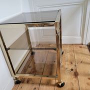 Gold metal and smoked glass serving trolley
