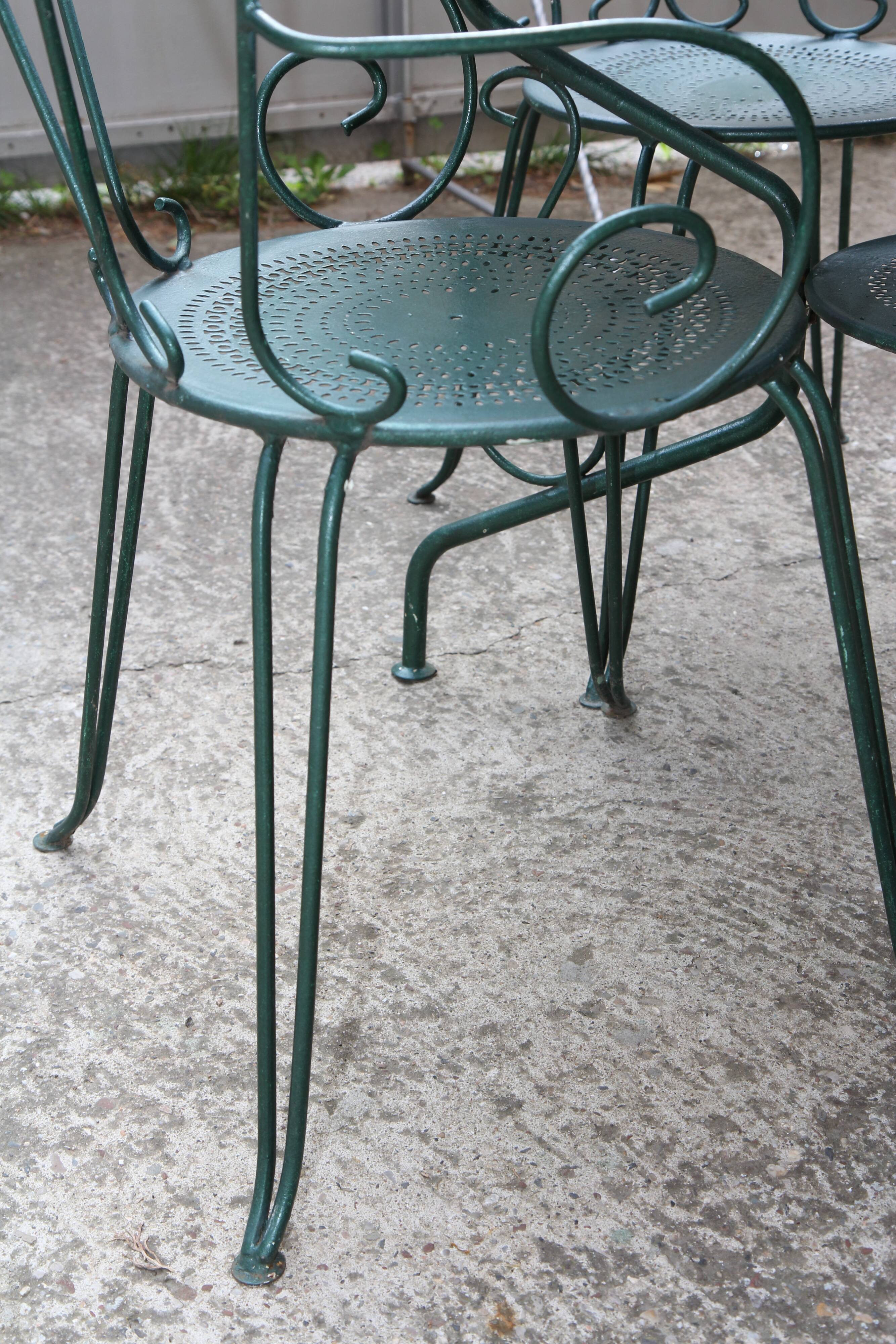 Old wrought iron garden furniture, 2 armchairs, 2 chairs and the table