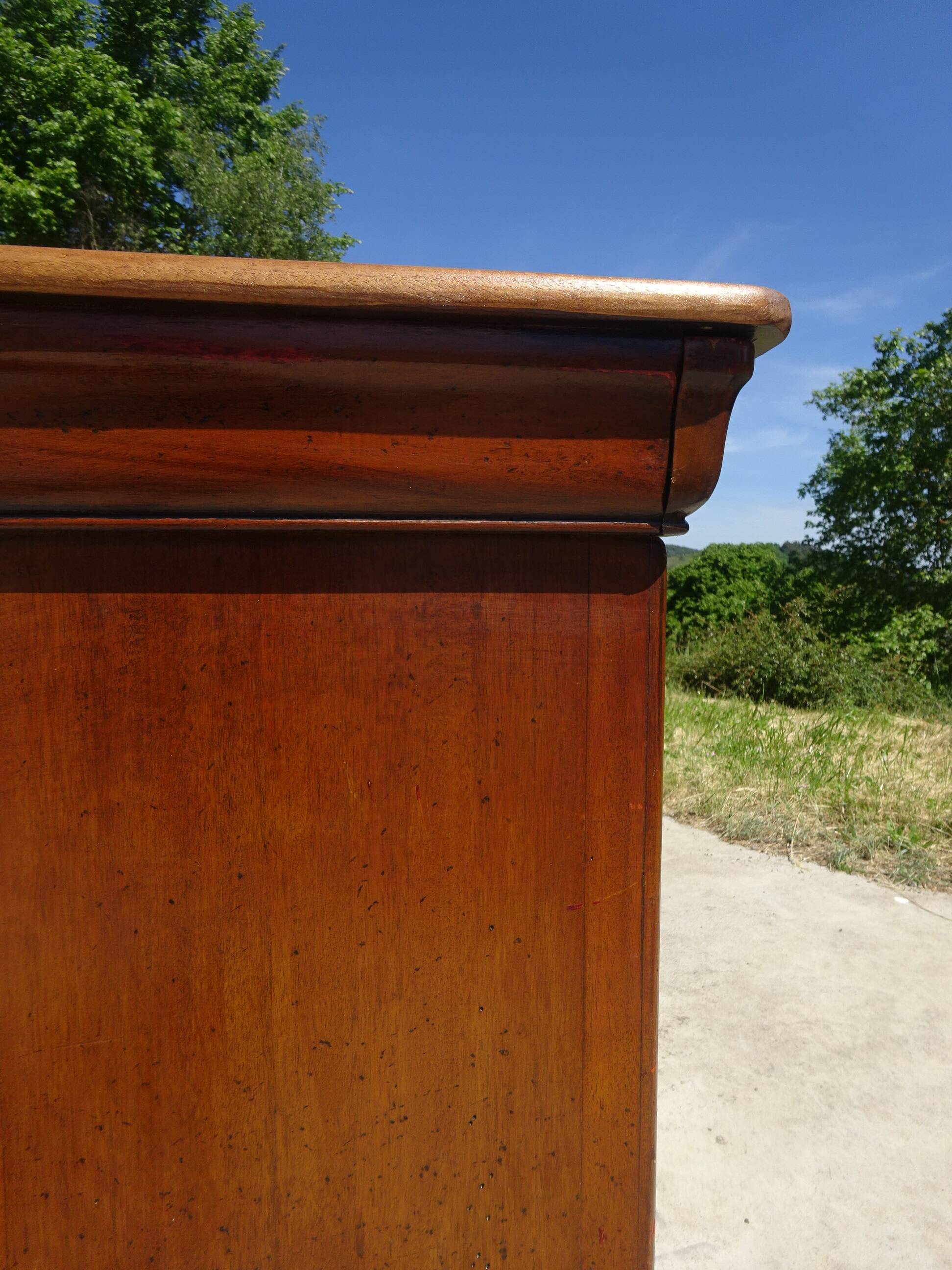 Chest of drawers with decorated handles in the Louis XVI style.