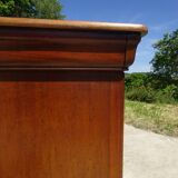 Chest of drawers with decorated handles in the Louis XVI style.