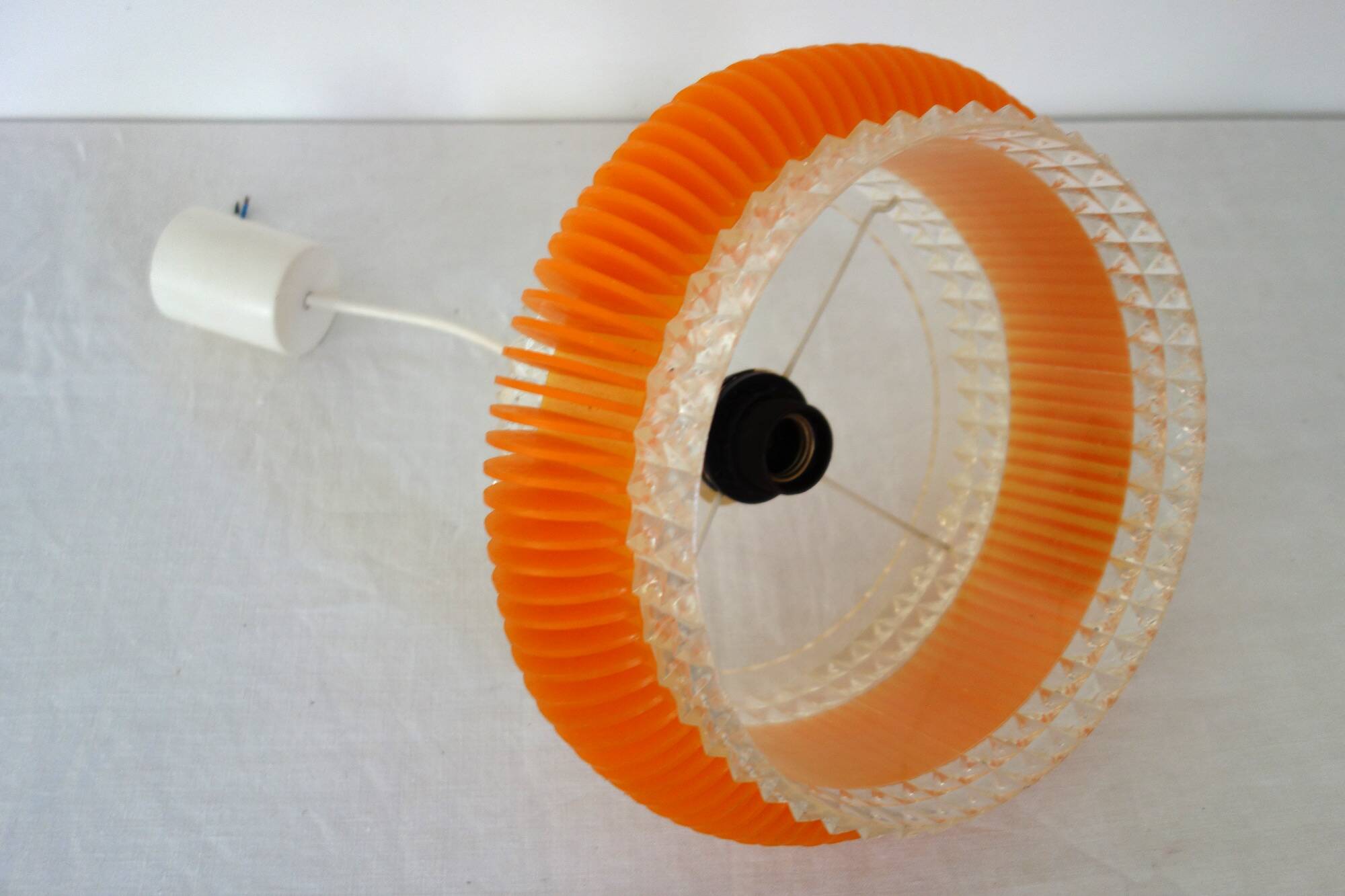 Transparent plastic space age lustre with orange band from the 70s.
