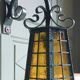 Wrought iron wall lantern & amber cathedral glass