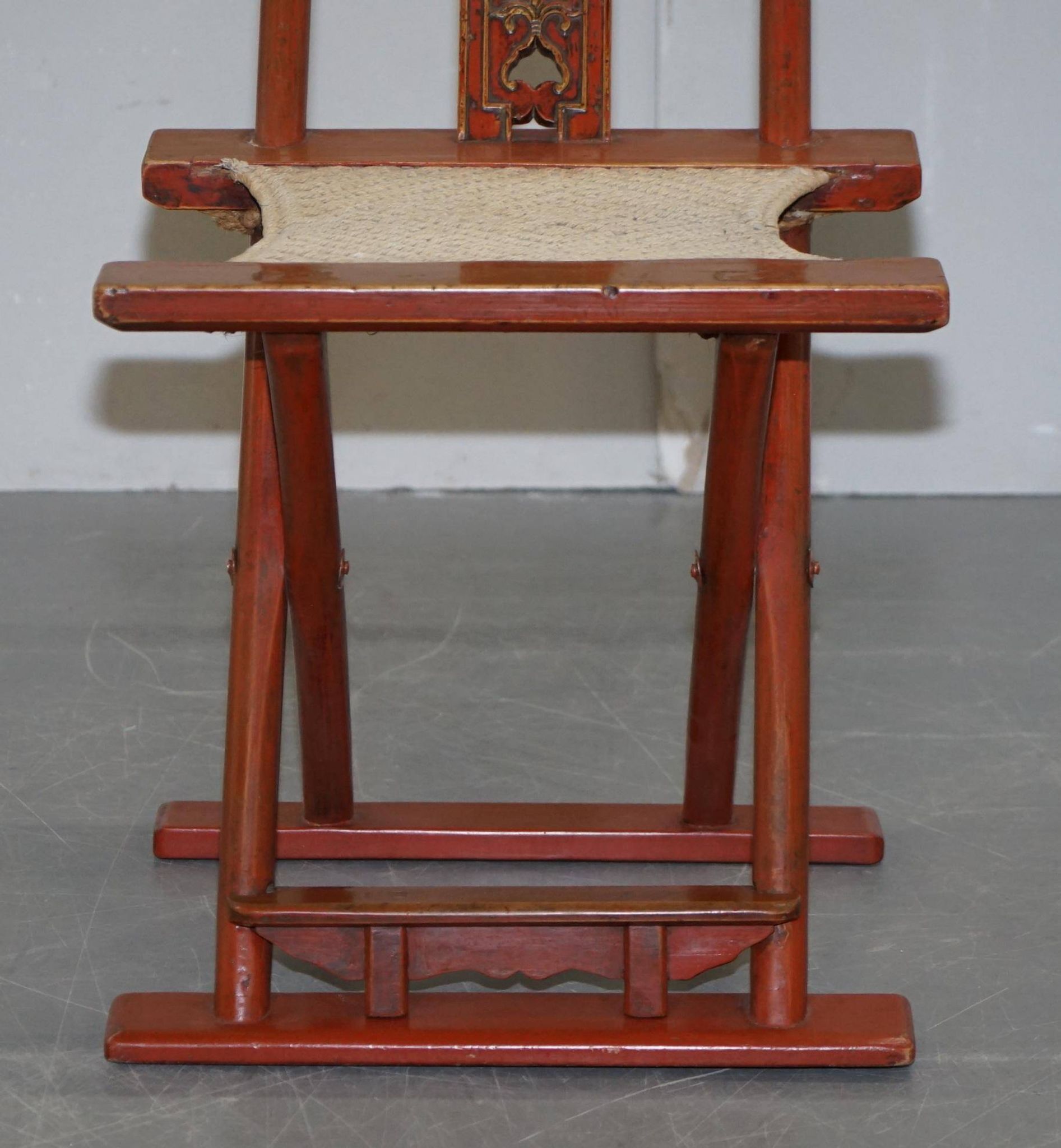 Antique Chinese folding chair with carvings, circa 1900-1920.