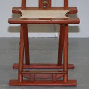 Antique Chinese folding chair with carvings, circa 1900-1920.