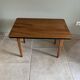 Mid-century coffee table with tapered legs.