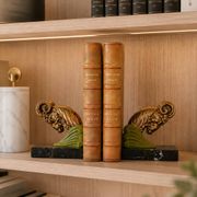 Art Deco pair of bookends with ram's heads, patinated metal and black marble.