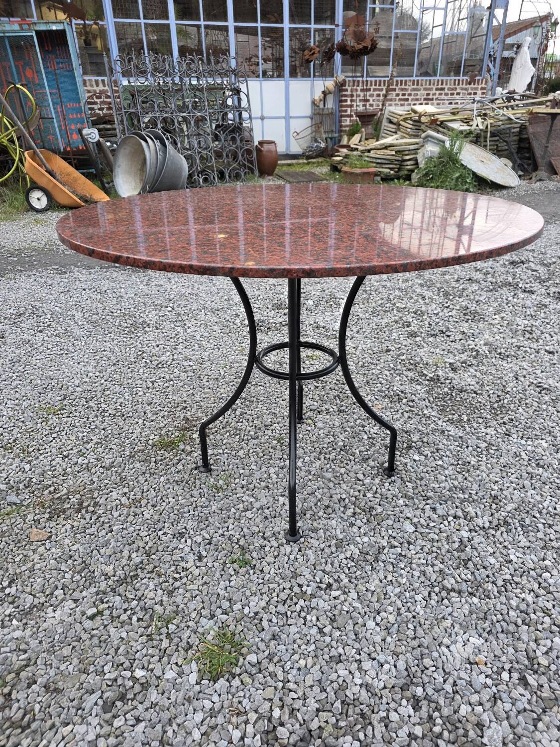 Round marble table with wrought iron base from the mid-20th century.
