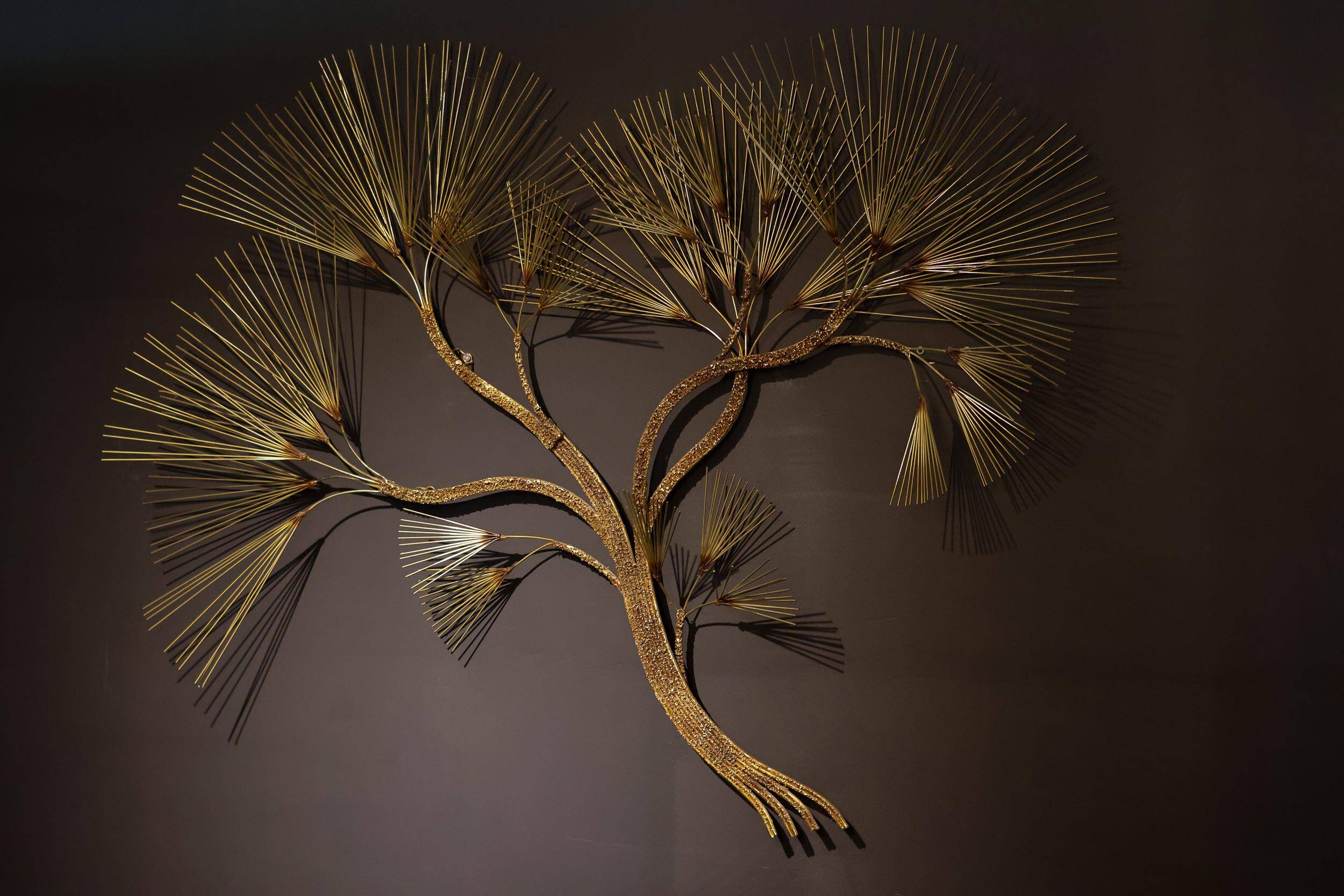 Large wall sculpture in the shape of a tree needle in brass by Curtis Jeré, mid-century modern.
