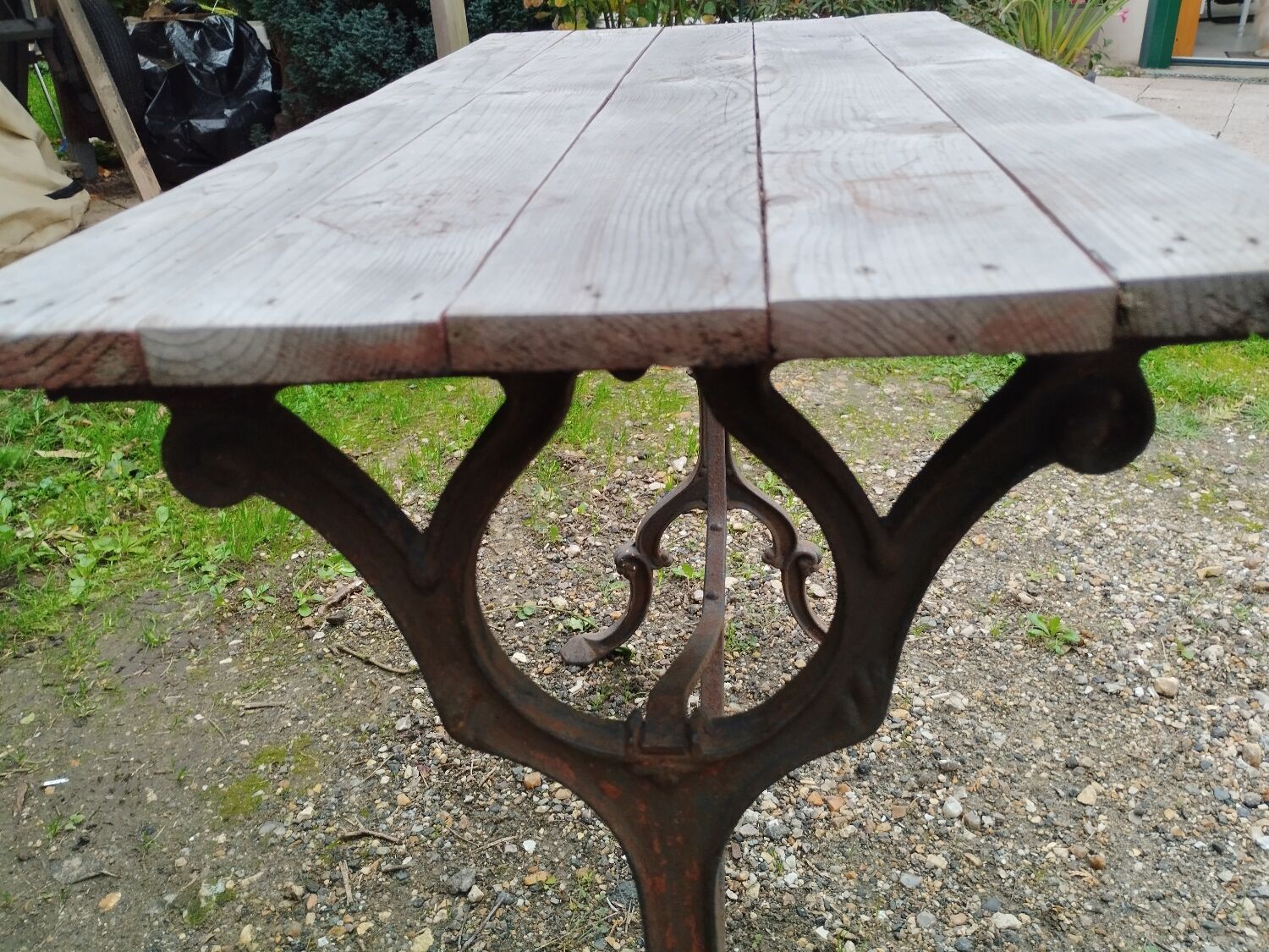 Antique bistro table with iron legs and wooden top