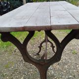 Antique bistro table with iron legs and wooden top