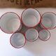 Series of 6 spice pots in white and red enamel for cooking
