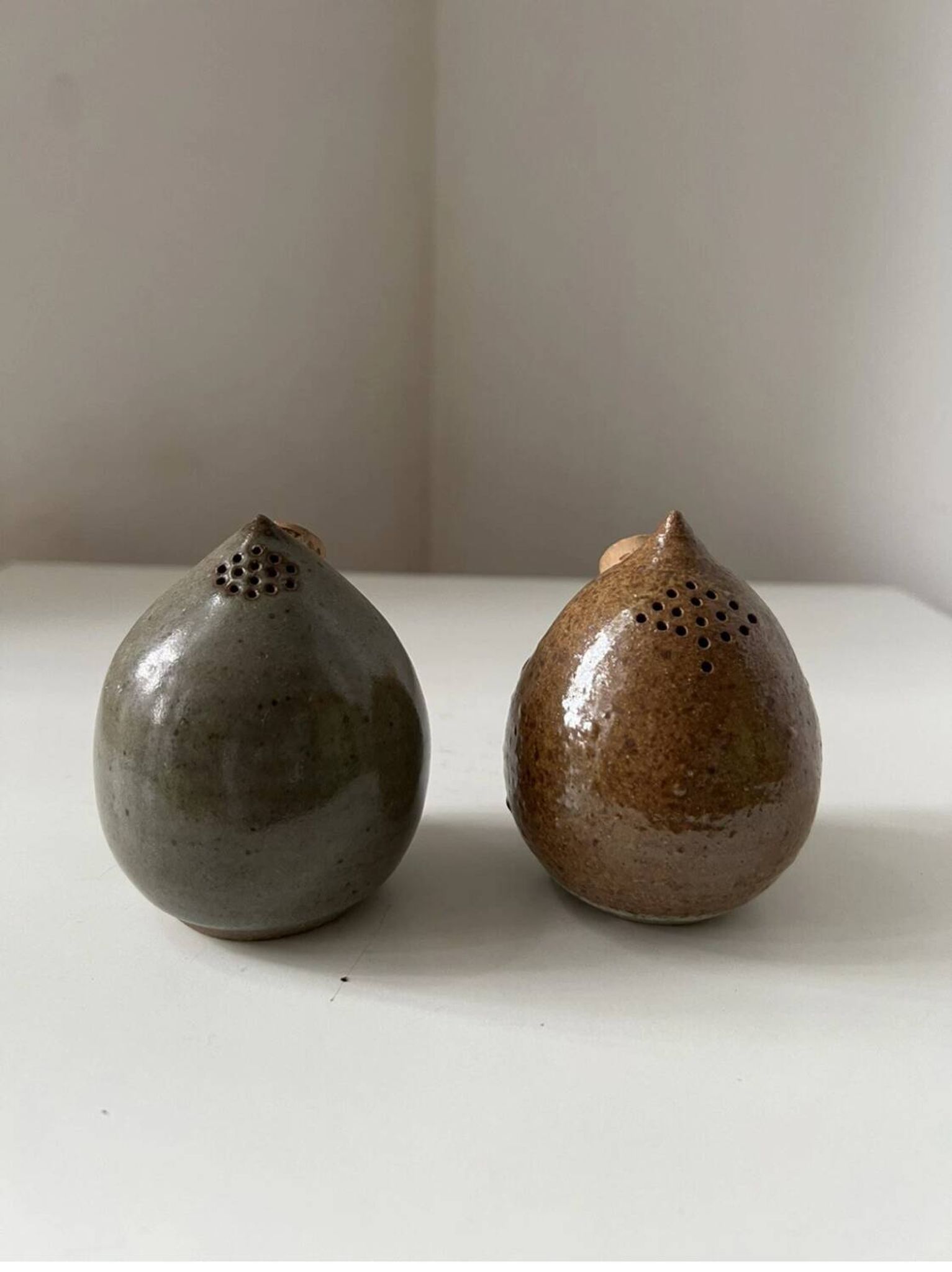 Pair of vintage round stoneware salt and pepper shakers