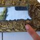 Miroir à parecloses en bois doré et métal repoussé