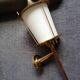 Wall lantern in gilded metal and glass