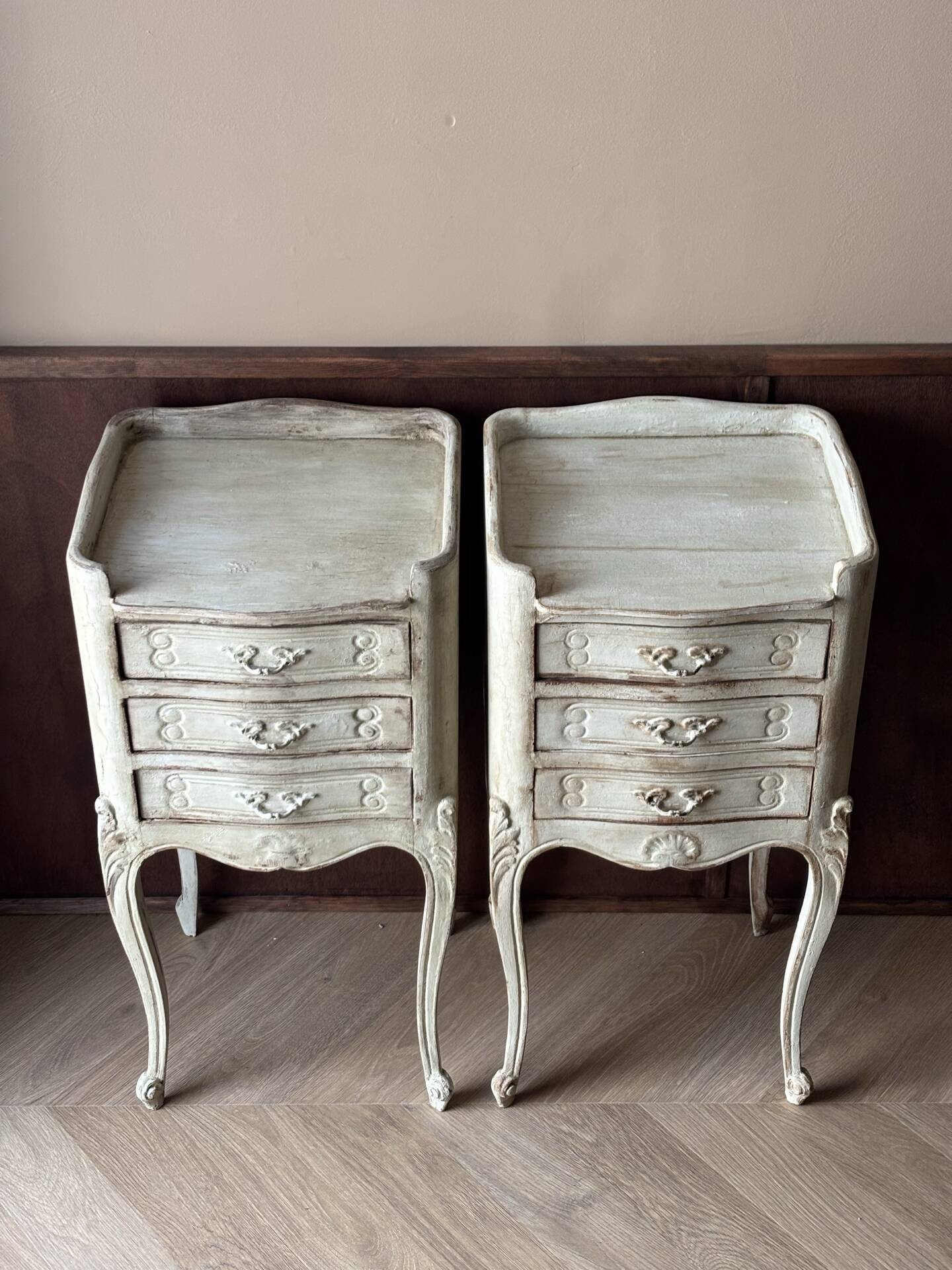 A pair of distressed bedside tables.