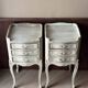 A pair of distressed bedside tables.