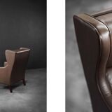 Brown leather wingback chair in mid-century modern Danish style, 1960s.