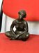 Bronze sculpture of a seated woman