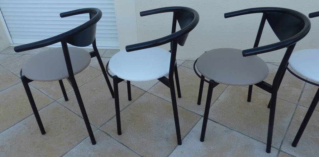 6 gondola-style chairs with a sturdy metal frame and faux leather.