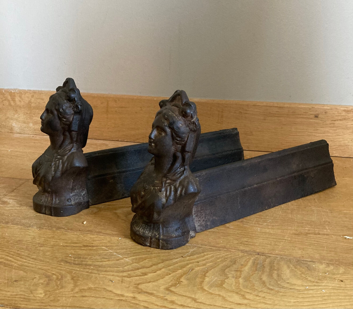 Pair of cast iron andirons from the 19th century, busts of women