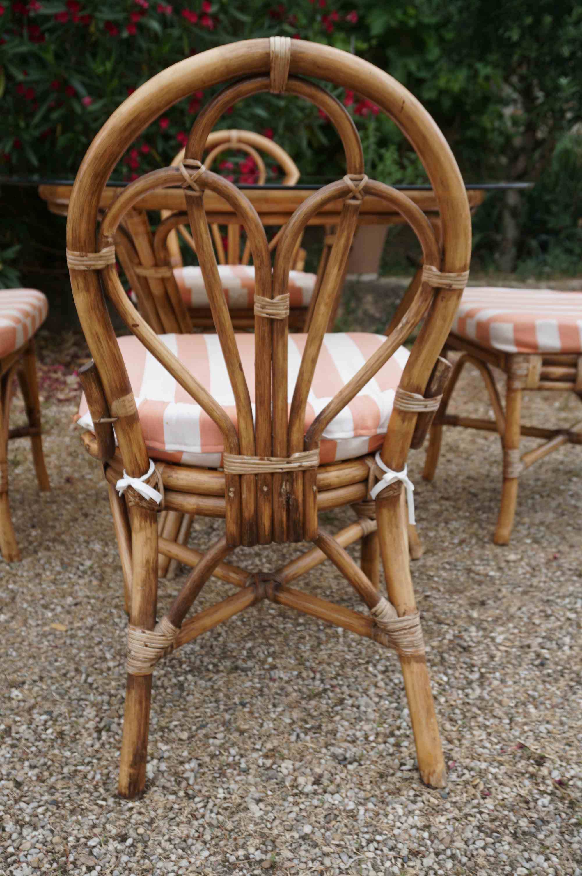 dining table and chairs made of curved bamboo and rattan with smoked glass from the 1970s