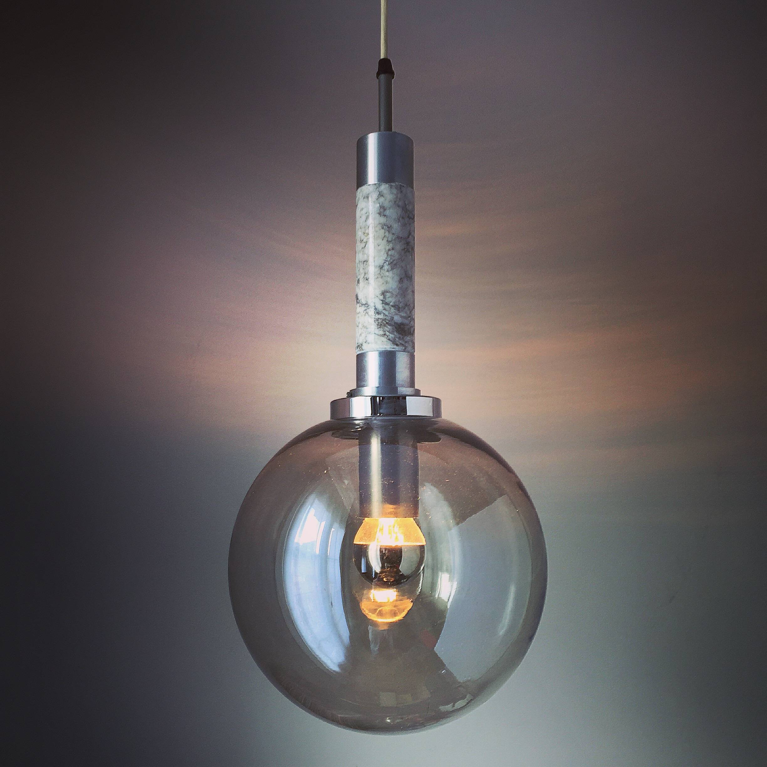 Scandinavian pendant light in brushed stainless steel marble and smoked glass globe. 1970