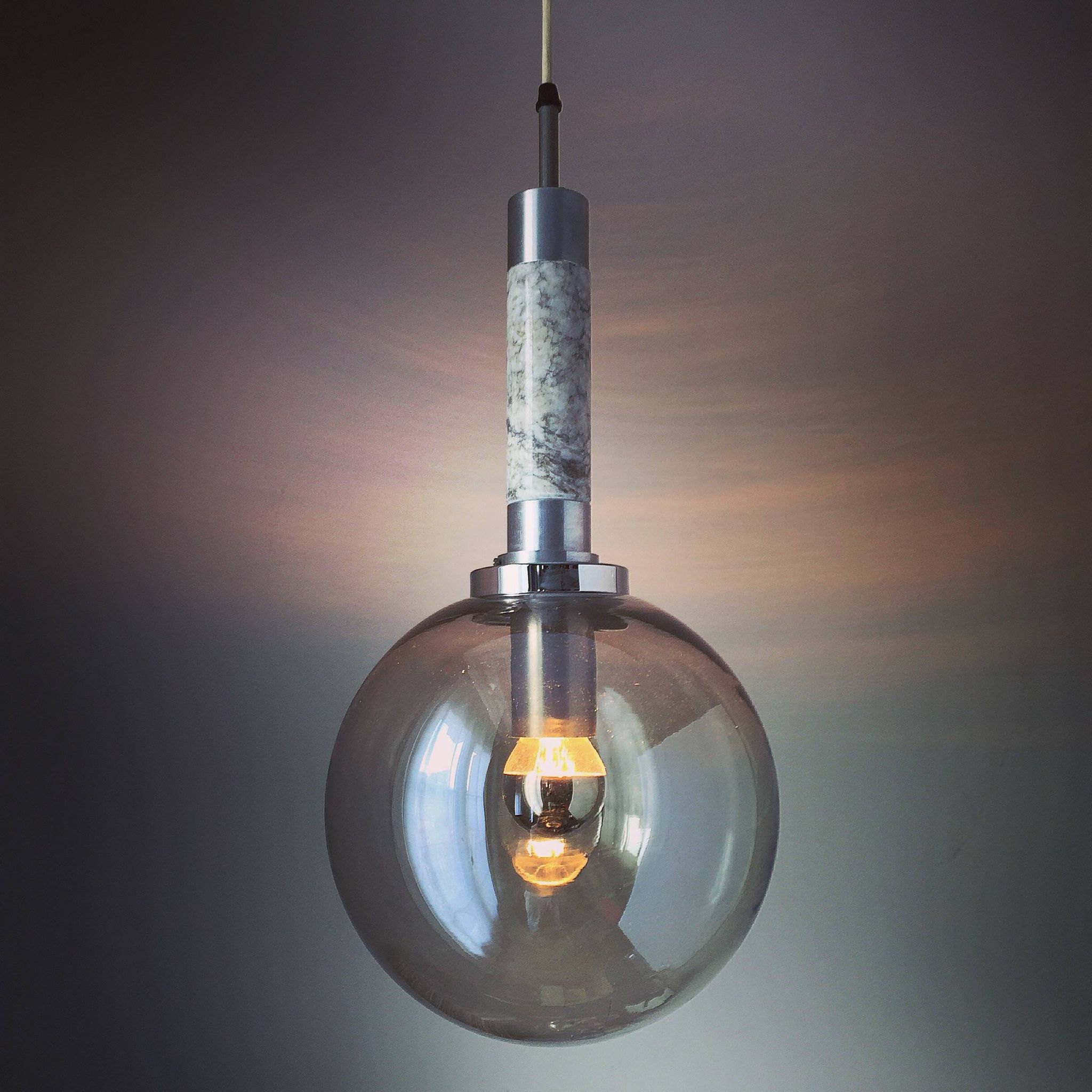 Scandinavian pendant light in brushed stainless steel marble and smoked glass globe. 1970