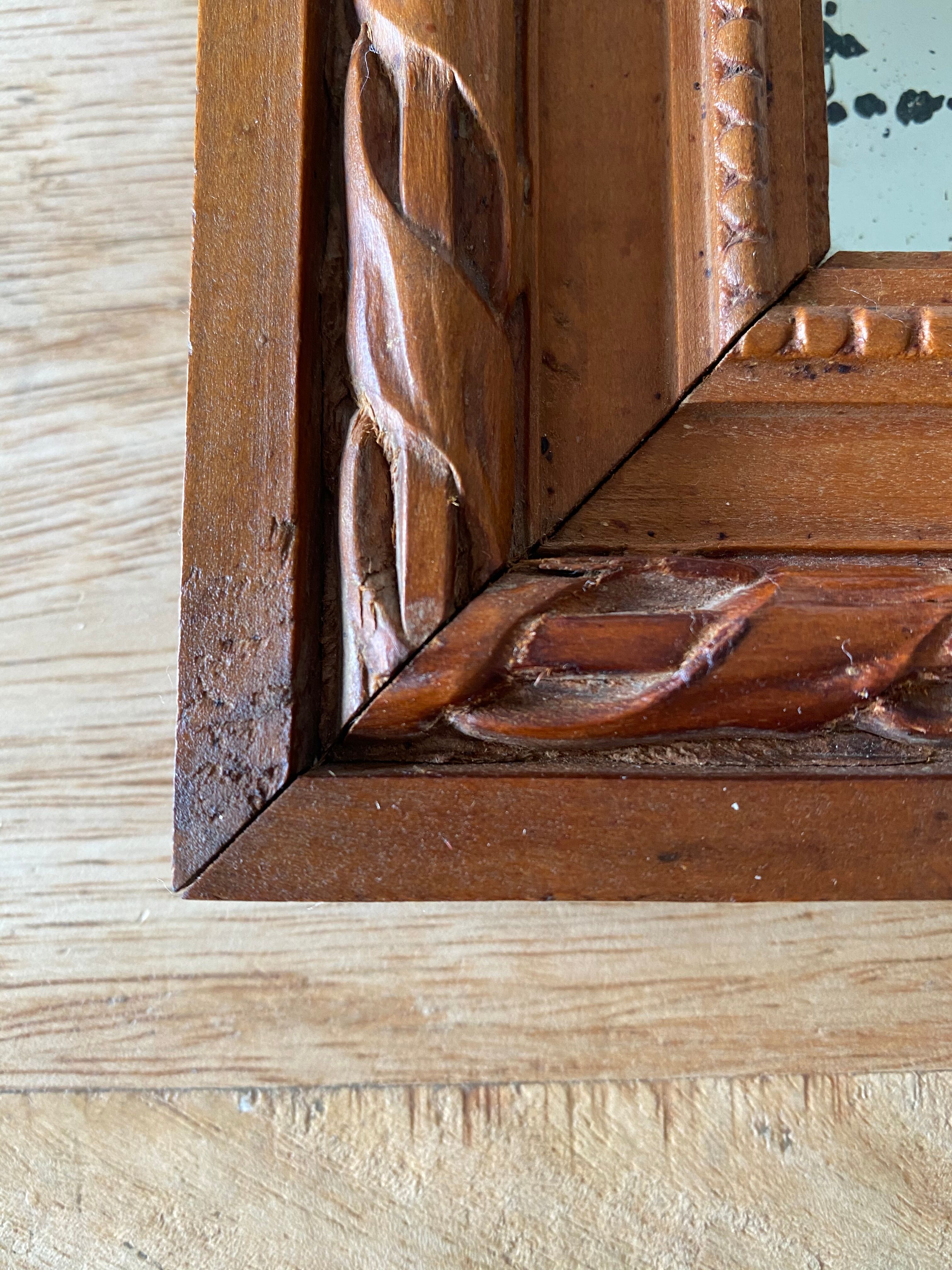 Antique mirror in carved wood and mercury 48x63cm