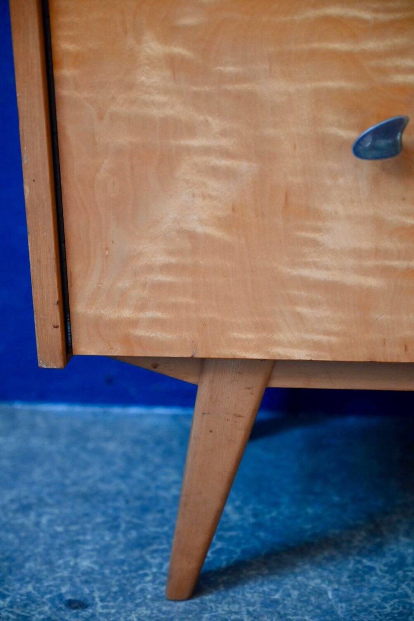 Rockabilly design bedside table with tapered legs.
