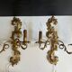 Pair of Italian Hollywood Regency wall lights in iron and gilded sheet metal.