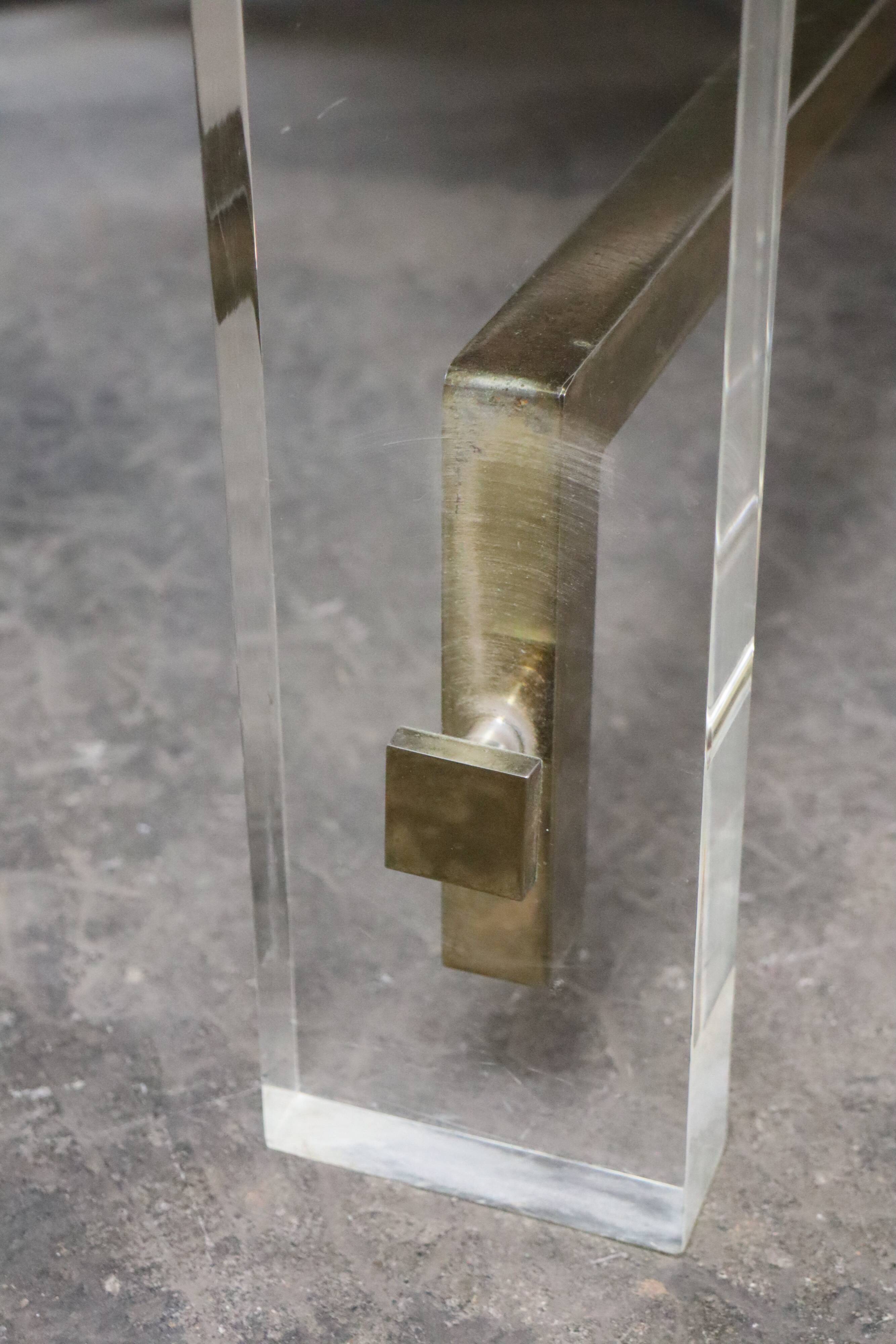 1970s dining table in travertine, gold metal and plexiglass.