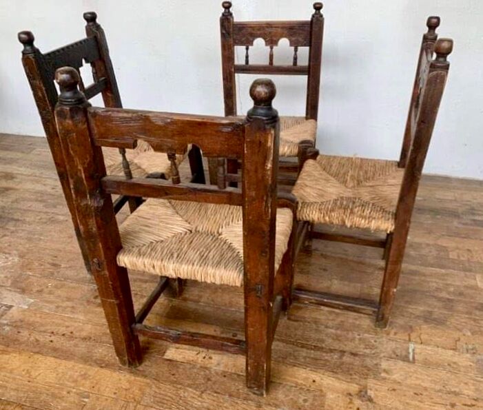 Series of 4 brutalist rustic chairs in carved wood straw seat