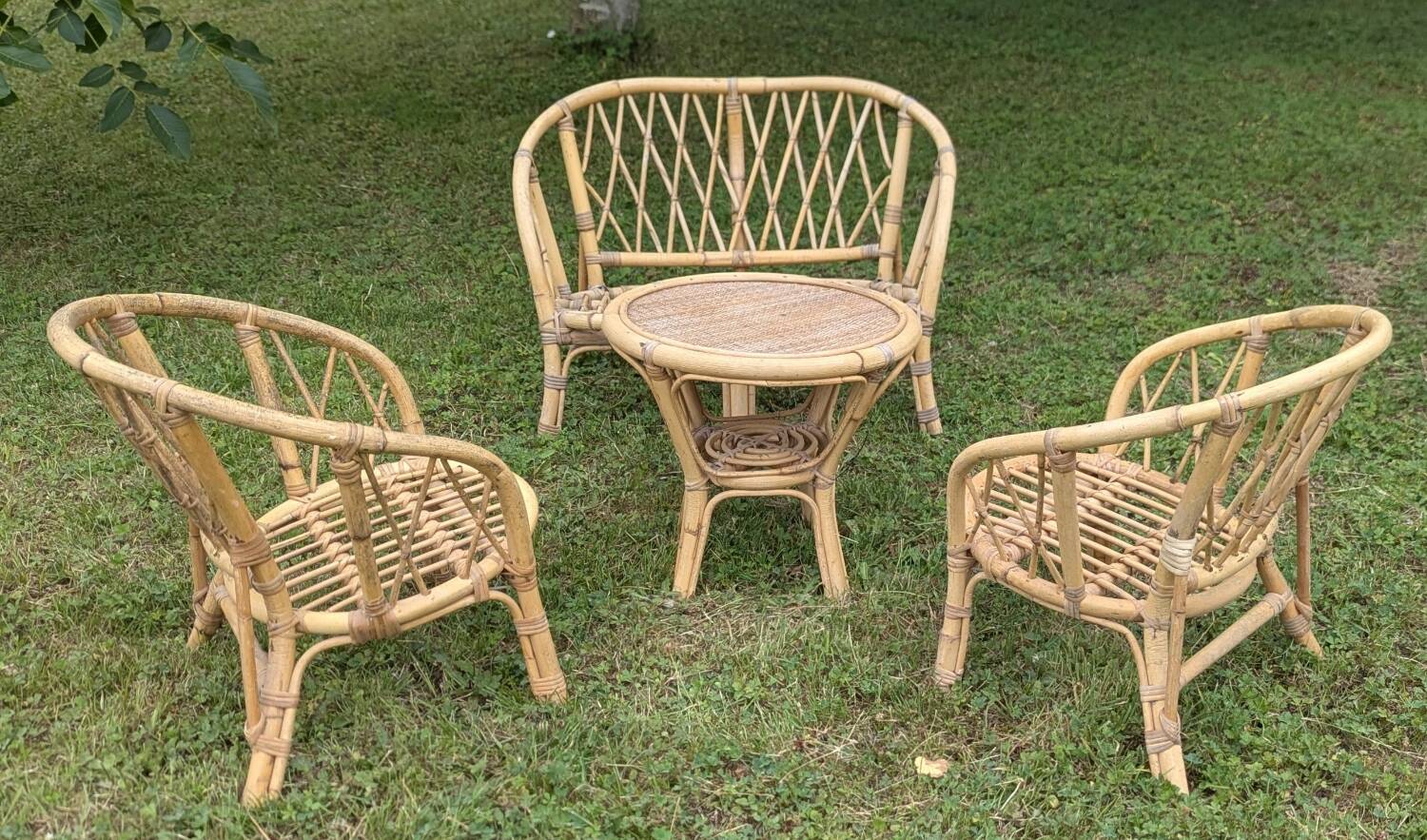Set of children's rattan garden furniture from the 1950s and 1960s, including chairs, table, and bench.