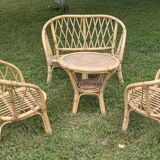 Set of children's rattan garden furniture from the 1950s and 1960s, including chairs, table, and bench.