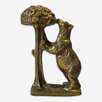 Brass sculpture, bear looking for honey in the tree