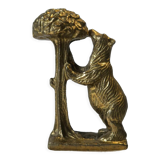 Brass sculpture, bear looking for honey in the tree