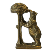 Brass sculpture, bear looking for honey in the tree