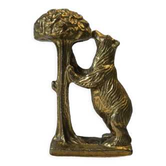 Brass sculpture, bear looking for honey in the tree