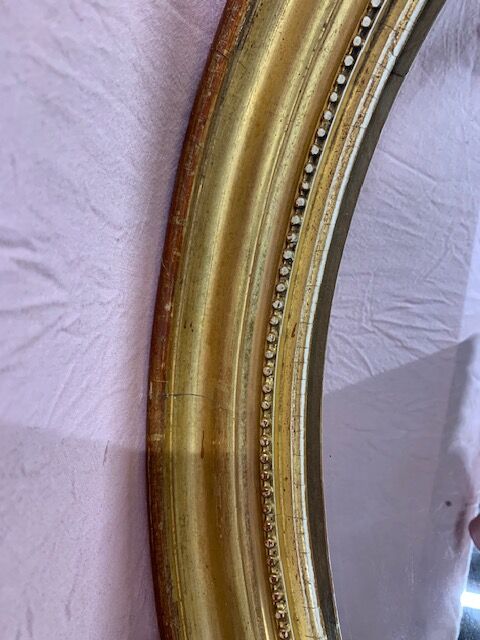 Golden oval mirror