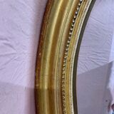 Golden oval mirror