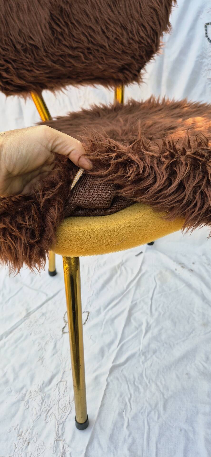 Vintage shaggy chair in faux fur with golden metal legs.
