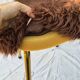 Vintage shaggy chair in faux fur with golden metal legs.