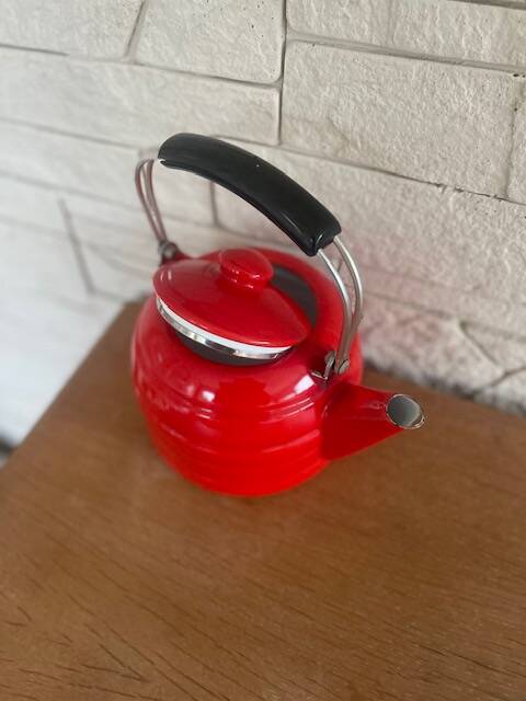 Old red enameled kettle