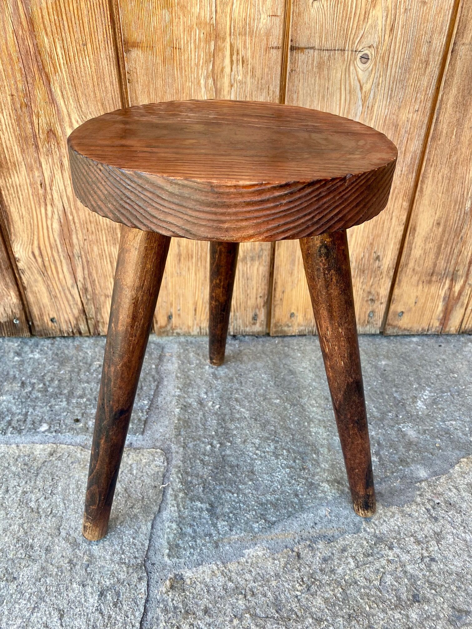 Wooden tripod stool.