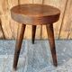 Wooden tripod stool.