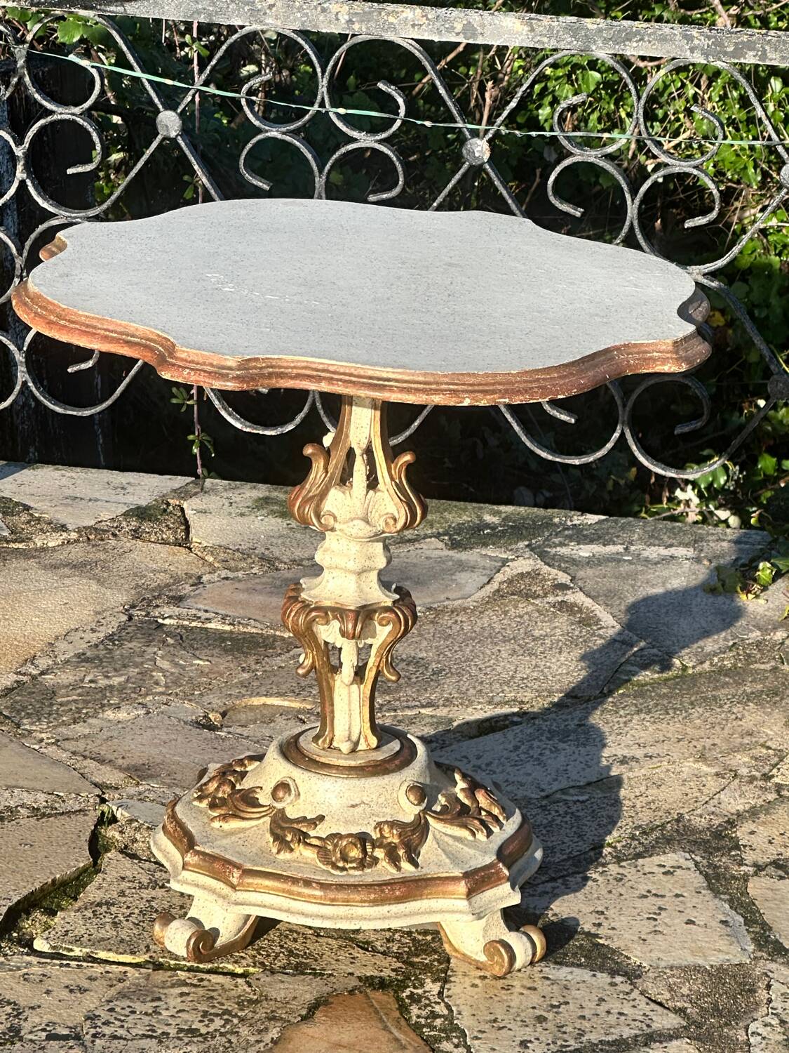 Carved and lacquered wooden side table.