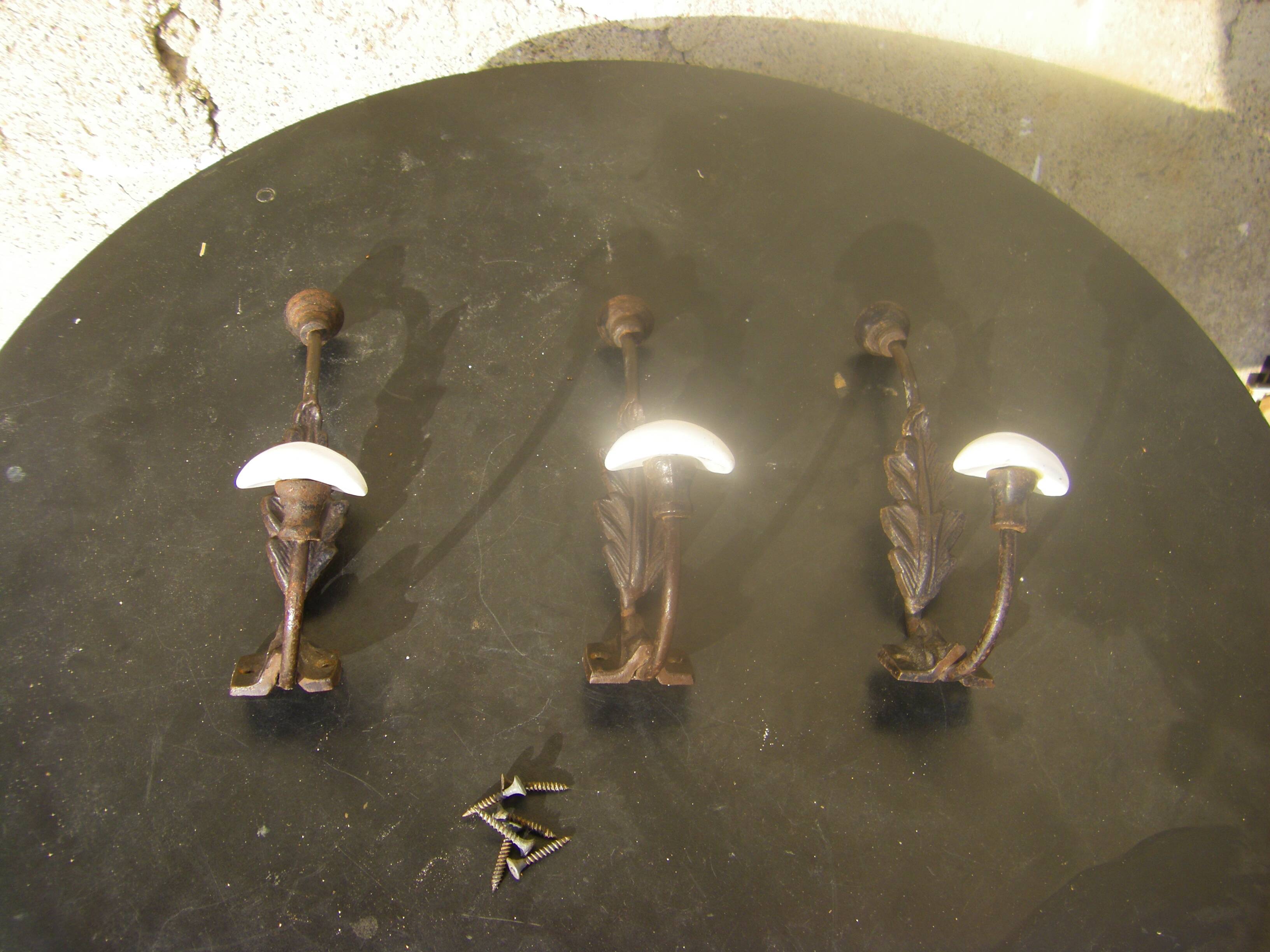 Trio of vintage coat hooks.