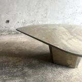 Light gray solid granite coffee table with organic triangular shape and conical base, 1980s